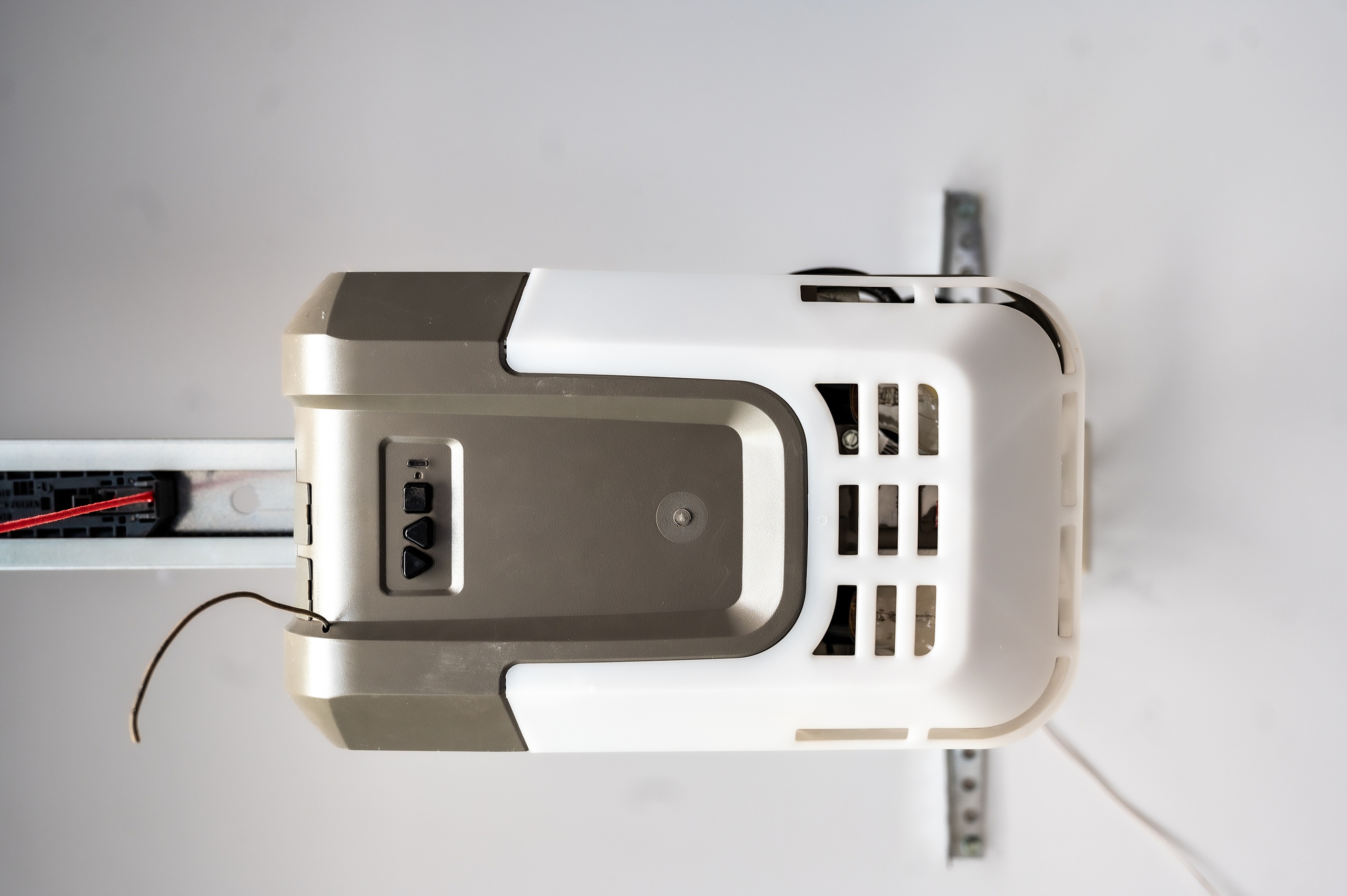 white and brown wooden house near green trees under blue sky during daytime