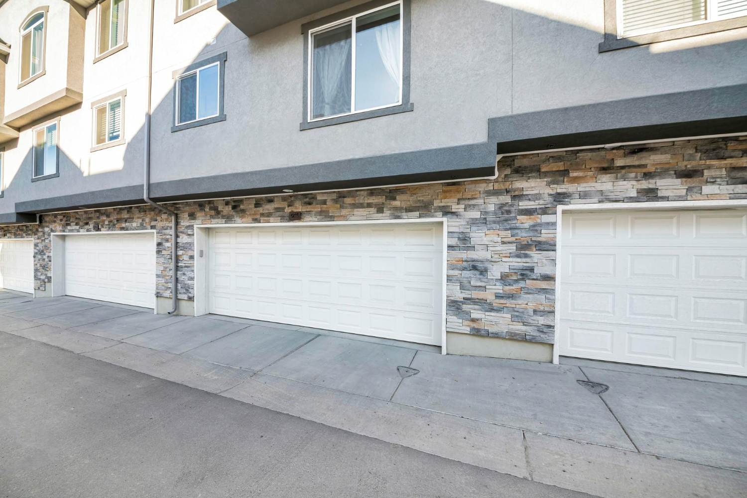 white and brown wooden house near green trees under blue sky during daytime